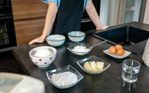 Midsection of man preparing food on table