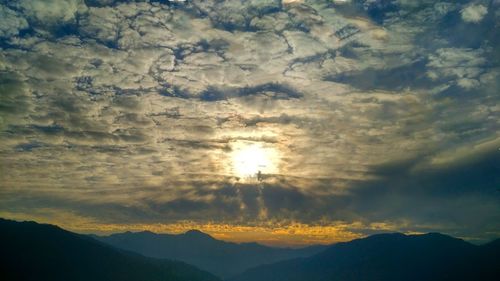 Scenic view of silhouette mountains against sky at sunset