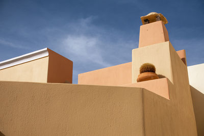 Low angle view of cross against building