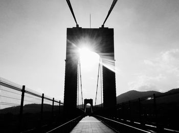 Sun shining through bridge