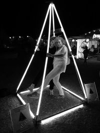 Full length of woman on swing at night