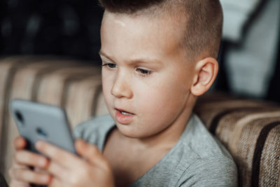 Portrait of boy using mobile phone