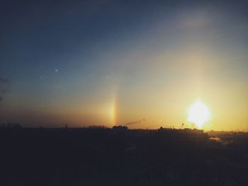Scenic view of field against sky at sunset