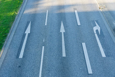 High angle view of arrow sign on road in city