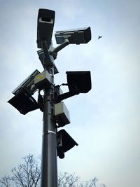 Low angle view of telephone pole against sky