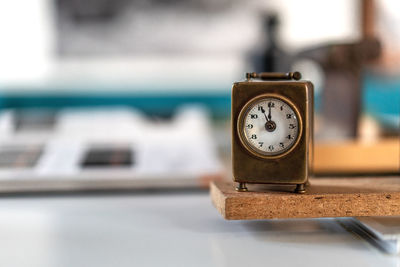 Close-up of vintage clock on table