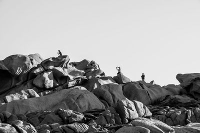 Rocks on land against clear sky