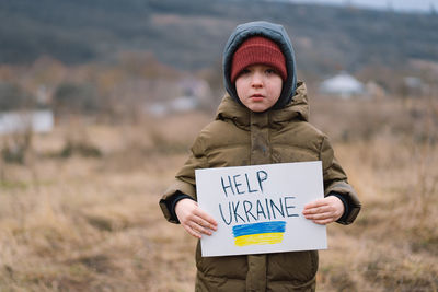 War of russia against ukraine. crying boy asks to stop the war in ukraine.