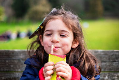 Portrait of smiling young woman blowing bubbles