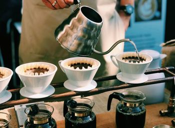 Close-up of pouring coffee cup on table