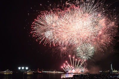 Low angle view of firework display at night