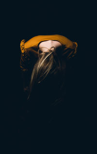 Rear view of man against black background