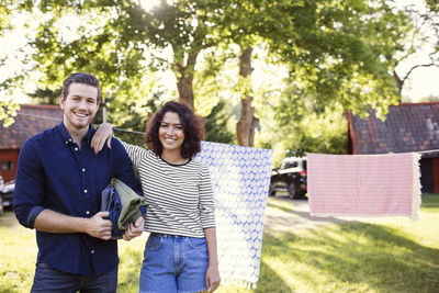 Smiling young couple standing outdoors