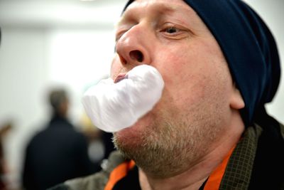 Close-up of man blowing bubble gum