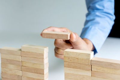 Close-up of man playing with toy on wood