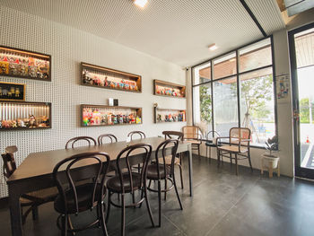 Empty chairs and tables in restaurant