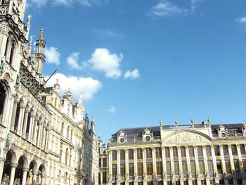 Low angle view of buildings against blue sky