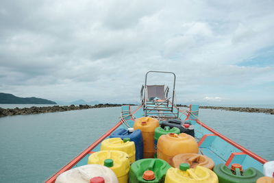 Container floating on lake against sky