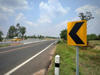 Road sign against sky