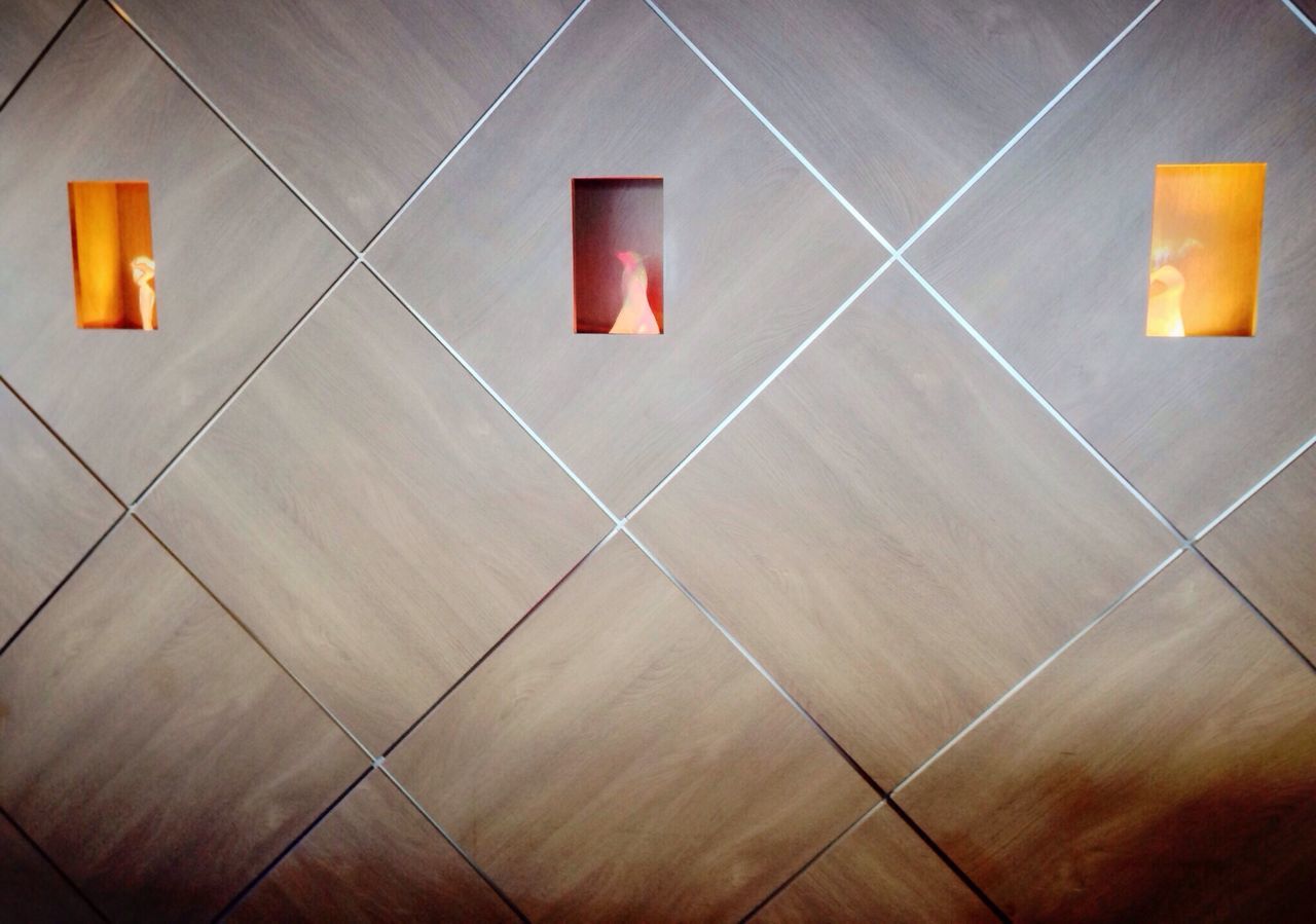 indoors, high angle view, flooring, tiled floor, still life, yellow, floor, absence, no people, empty, paper, red, multi colored, table, wall - building feature, close-up, tile, pattern, arrow symbol, illuminated