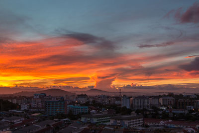 High angle view of townscape against orange sky