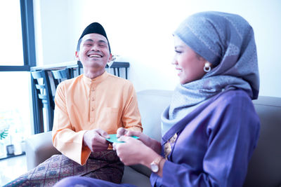 Husband and wife sharing gift during the eid festival