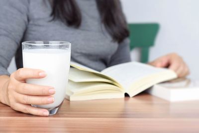 Midsection of woman holding book