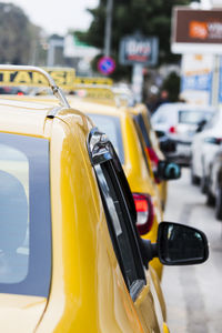 Close-up of yellow taxis on street