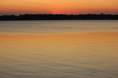 Scenic view of sea against romantic sky at sunset