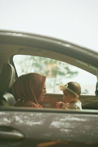 Reflection of man on car window