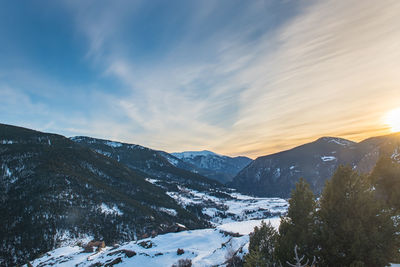 Scenic view of snowcapped mountains against sky during sunset