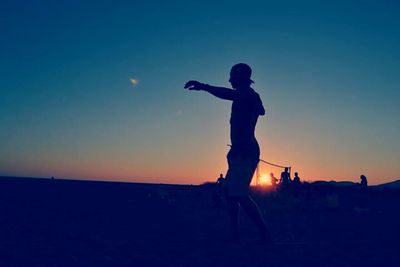 Silhouette of woman at sunset