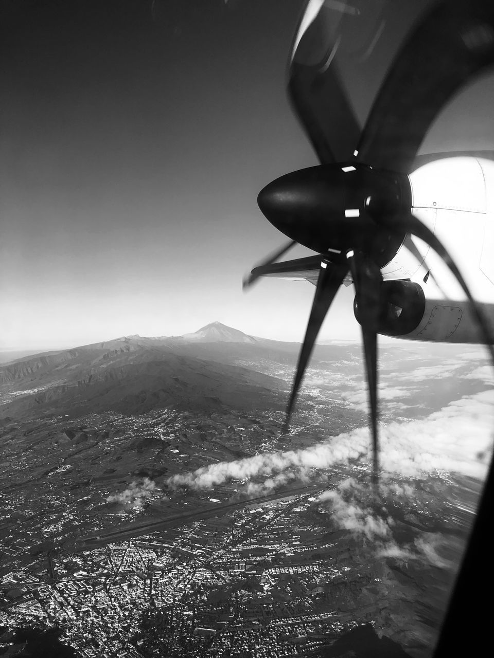 AIRPLANE FLYING OVER MOUNTAINS