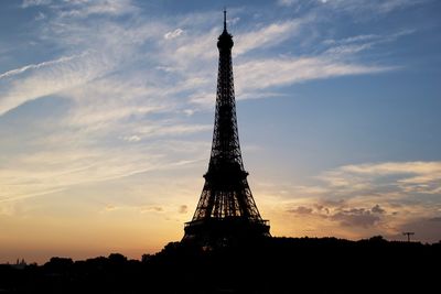 Low angle view of eiffel tower against sky during sunset