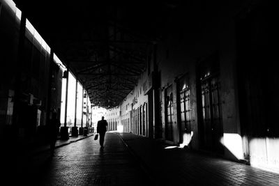 Man walking in corridor of building