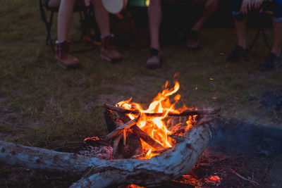 Low section of people with fire on field