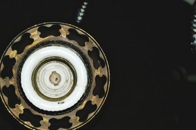 Close-up of electric lamp against black background