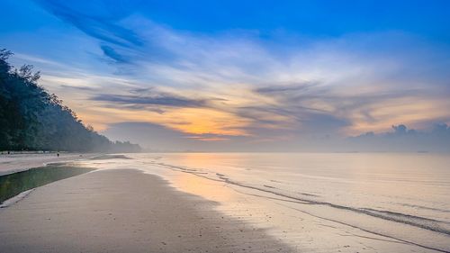 Scenic view of beach against sky during sunset
