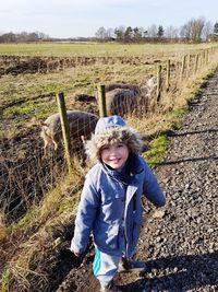 High angle portrait of cute smiling boy standing on field