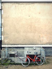 Bicycle parked against wall