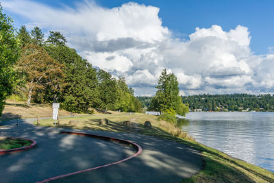 Billowing clouds hover over seward park in seattle, washington.