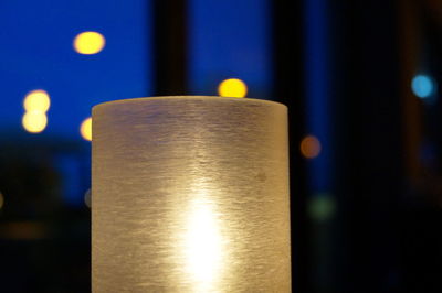 Close-up of illuminated electric lamp on table