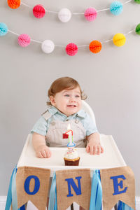 Portrait of cute girl having food on table