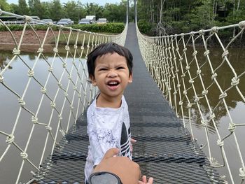 Portrait of girl on suspension bridge