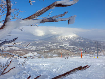 Scenic view of snow covered mountains against sky