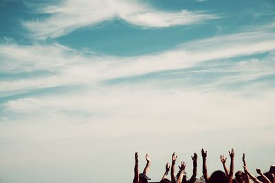 Low angle view of people against sky