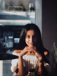 Portrait of woman drinking glass in restaurant