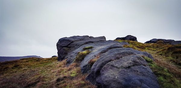 Low angle view of rock formation against sky