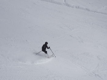 High angle view of person skiing on snow covered landscape