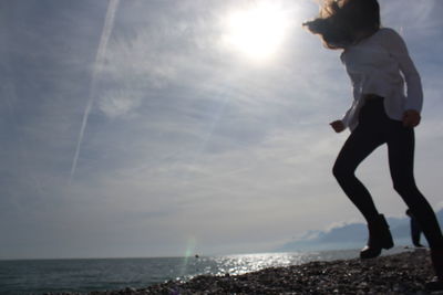 Man standing on beach against sky